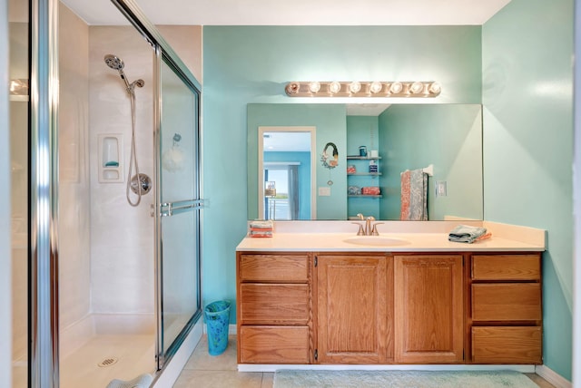 bathroom featuring a shower stall, vanity, and tile patterned floors