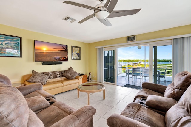 living room with visible vents, ceiling fan, and light tile patterned flooring