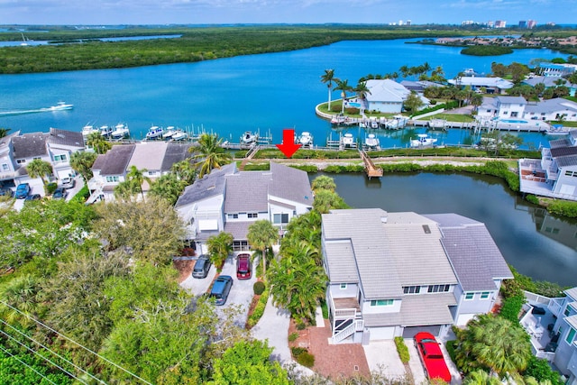 birds eye view of property with a residential view and a water view