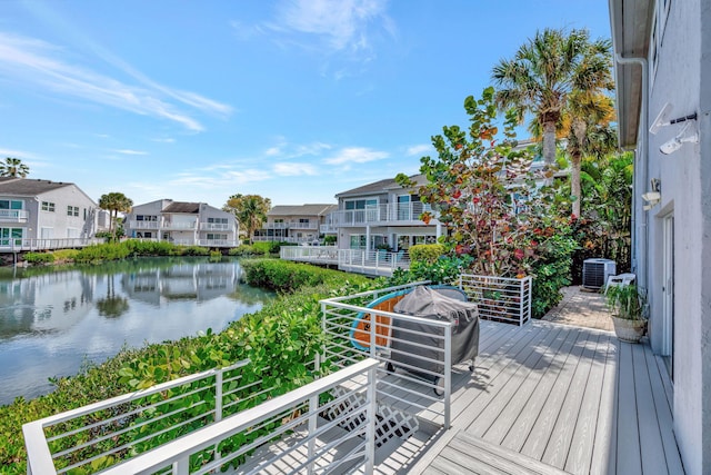 deck with a water view, a residential view, and area for grilling