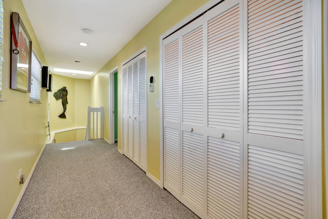 corridor featuring carpet, baseboards, and recessed lighting