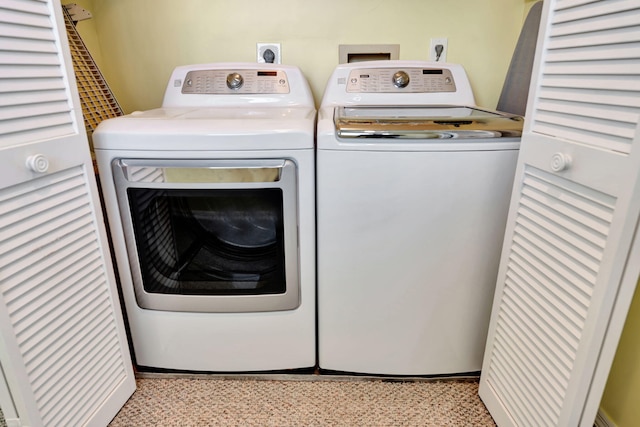 clothes washing area with washer and dryer and laundry area