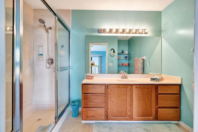 bathroom with tile patterned flooring, a shower stall, and vanity