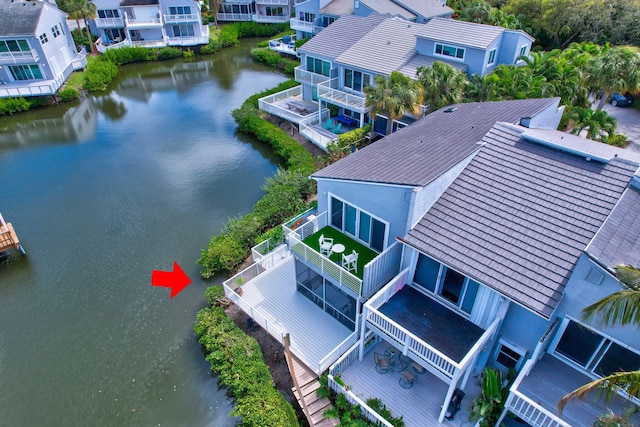 birds eye view of property featuring a water view and a residential view