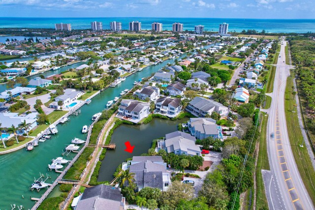 drone / aerial view featuring a water view and a residential view