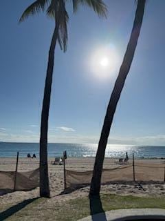 view of water feature with fence and a view of the beach