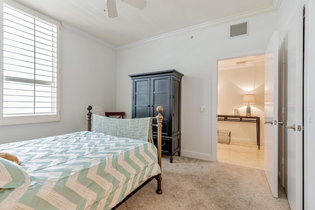 carpeted bedroom with a ceiling fan, visible vents, crown molding, and baseboards