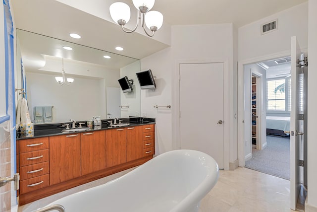 full bath with a notable chandelier, recessed lighting, visible vents, vanity, and a freestanding bath