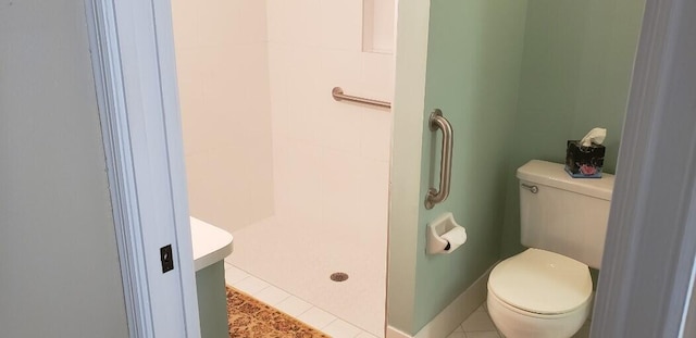 full bathroom with baseboards, a stall shower, toilet, and tile patterned floors