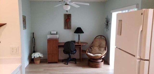 home office featuring light wood finished floors and a ceiling fan