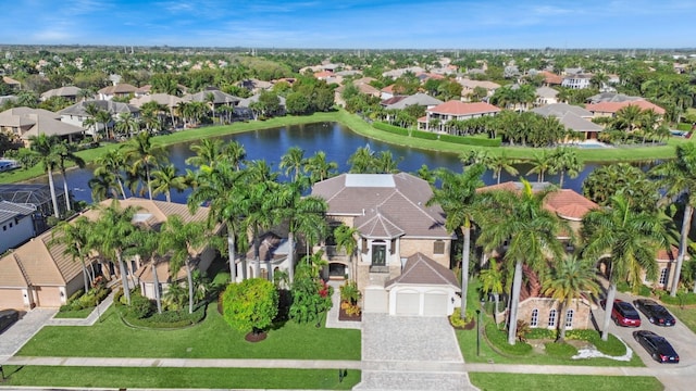 drone / aerial view featuring a residential view and a water view