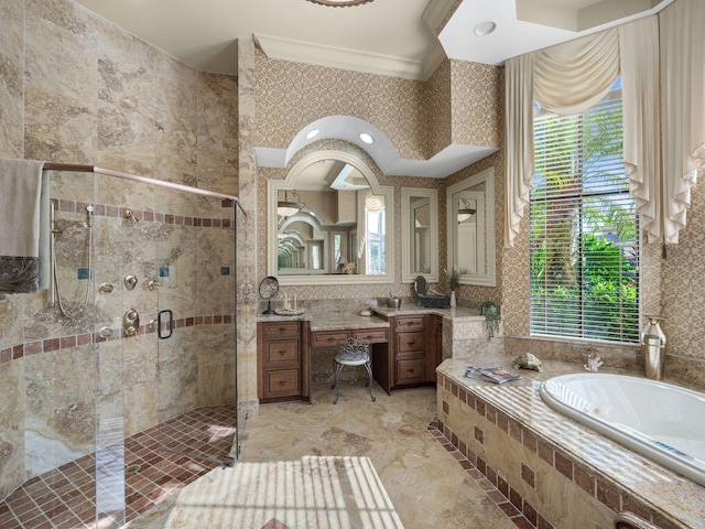 bathroom featuring a stall shower, vanity, a bath, and wallpapered walls