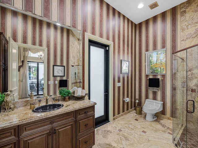 bathroom featuring visible vents, toilet, a stall shower, vanity, and wallpapered walls