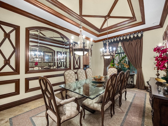 dining room featuring baseboards, a raised ceiling, and crown molding