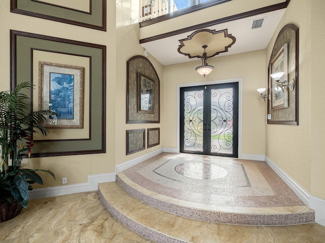 entrance foyer with french doors, visible vents, marble finish floor, and baseboards