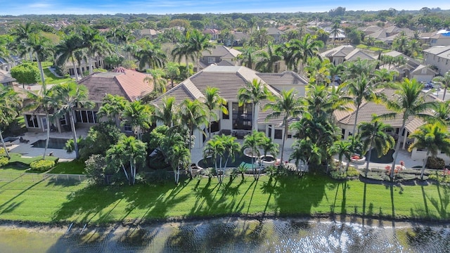 drone / aerial view with a residential view and a water view