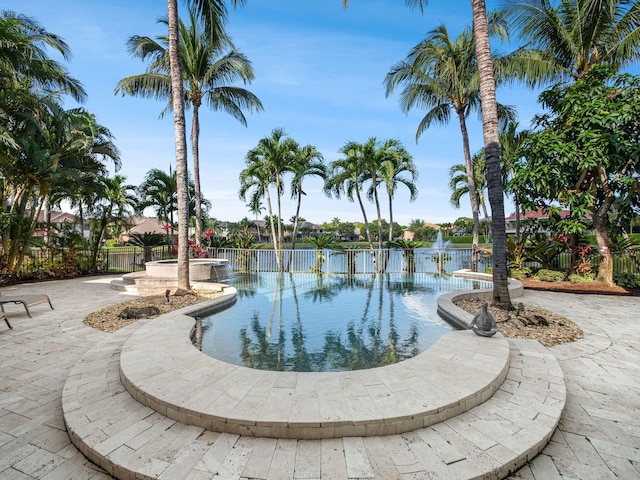 view of pool featuring fence