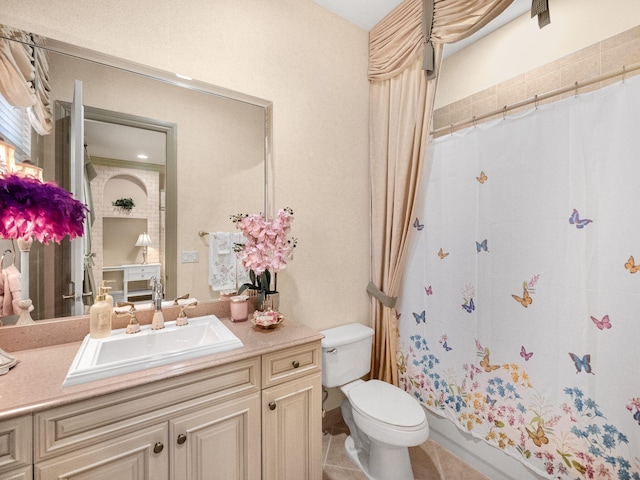 full bath featuring a shower with shower curtain, vanity, toilet, and tile patterned floors