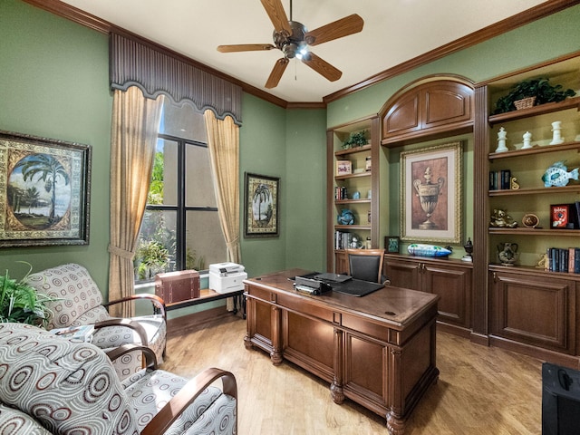 home office with ornamental molding, light wood-style flooring, and a ceiling fan