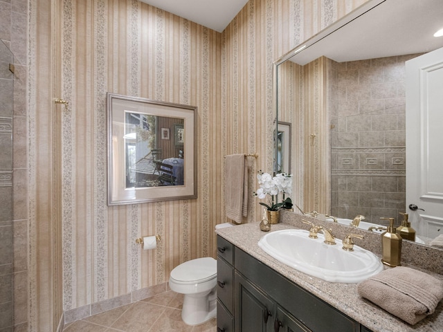 bathroom featuring tile patterned flooring, vanity, toilet, and wallpapered walls