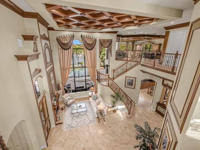 foyer featuring baseboards, coffered ceiling, stairs, crown molding, and beam ceiling