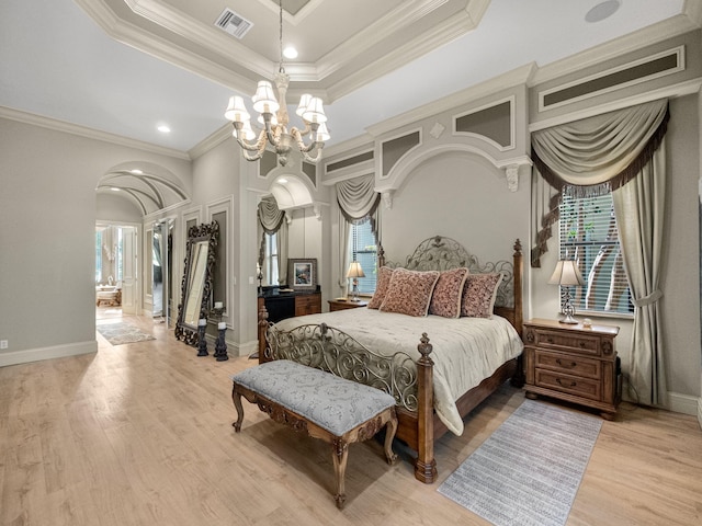 bedroom featuring an inviting chandelier, multiple windows, visible vents, and arched walkways