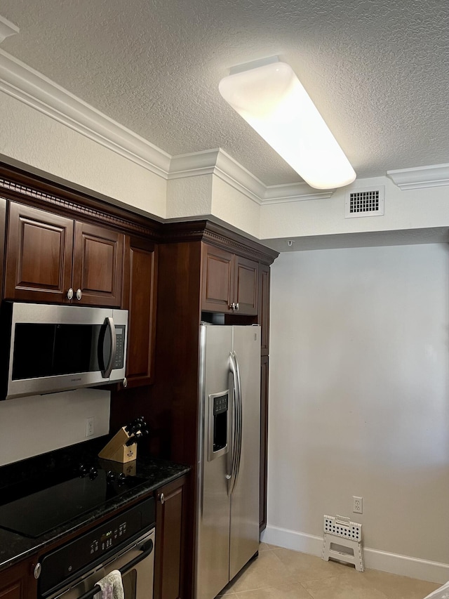 kitchen featuring a textured ceiling, dark brown cabinetry, visible vents, ornamental molding, and appliances with stainless steel finishes