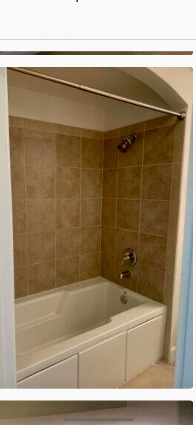 bathroom with bathing tub / shower combination