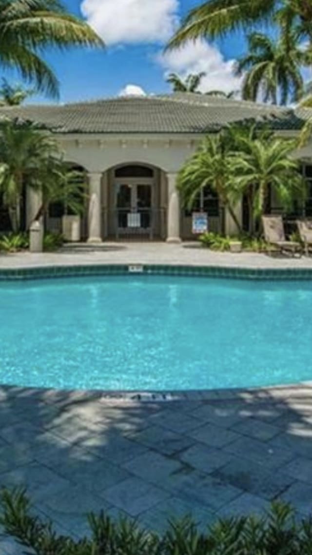 pool with an outbuilding and a patio