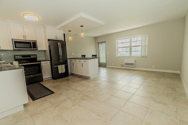 kitchen featuring stainless steel appliances, a peninsula, backsplash, and white cabinetry