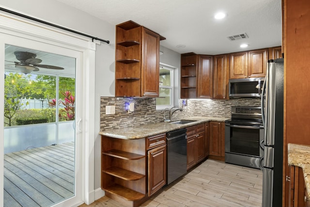 kitchen with open shelves, a sink, visible vents, and stainless steel appliances