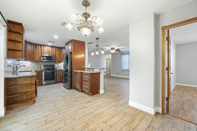 kitchen featuring stainless steel appliances, a sink, decorative backsplash, open shelves, and light wood finished floors