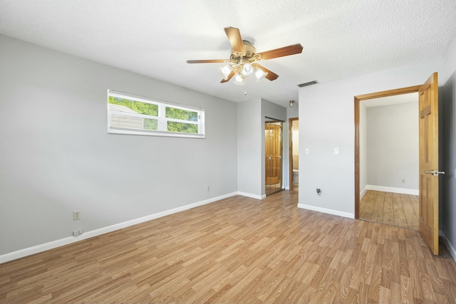 unfurnished bedroom with light wood finished floors, baseboards, visible vents, a ceiling fan, and a textured ceiling