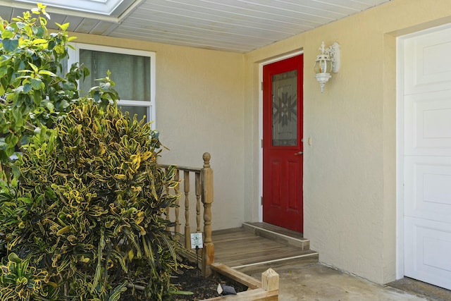 property entrance with stucco siding