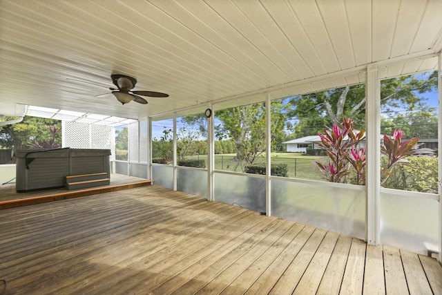 unfurnished sunroom with wooden ceiling and a ceiling fan