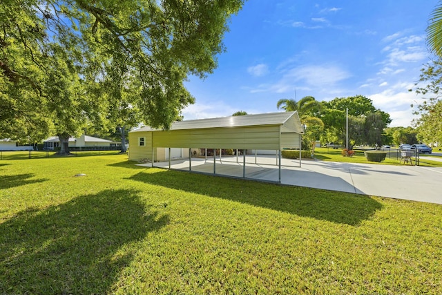 view of community with a carport, a yard, fence, and driveway