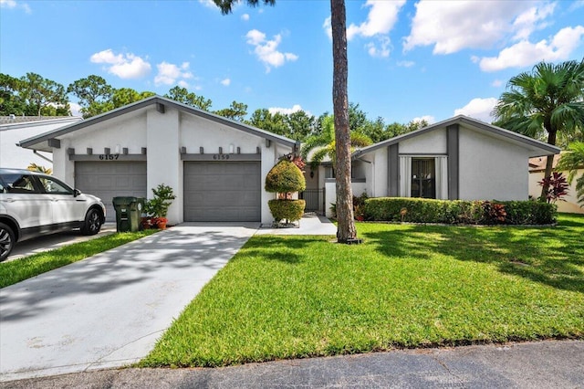 mid-century inspired home featuring a garage, a front yard, concrete driveway, and stucco siding