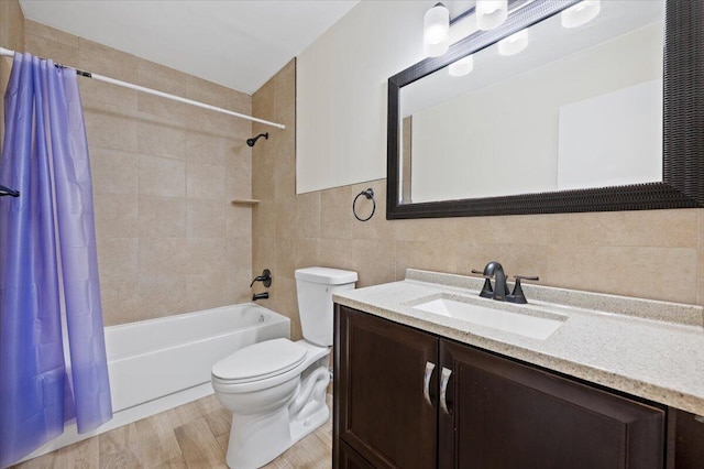 bathroom with toilet, vanity, tile walls, and shower / tub combo with curtain