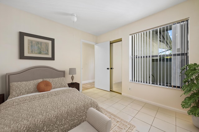 tiled bedroom with a closet and baseboards