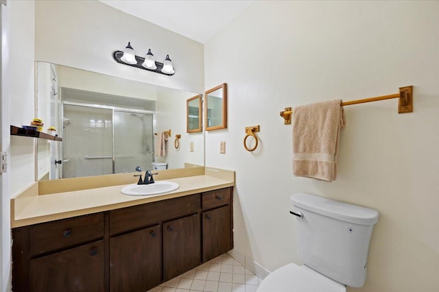 full bathroom featuring baseboards, toilet, tile patterned flooring, vanity, and a shower stall