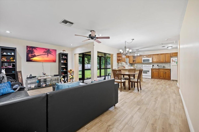 living area with recessed lighting, visible vents, ceiling fan, light wood-type flooring, and baseboards