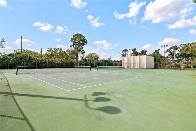 view of tennis court featuring fence