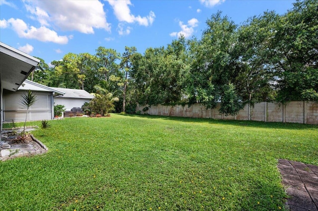 view of yard with fence and an attached garage