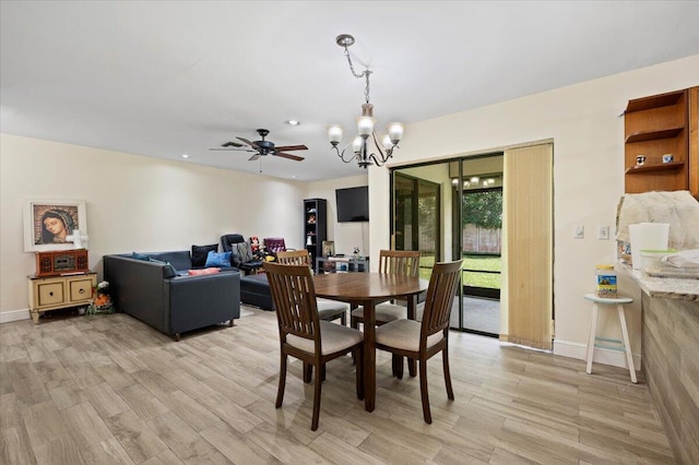 dining space with light wood finished floors, baseboards, a notable chandelier, and recessed lighting