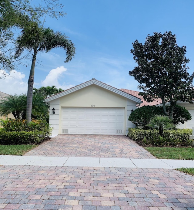 garage with decorative driveway