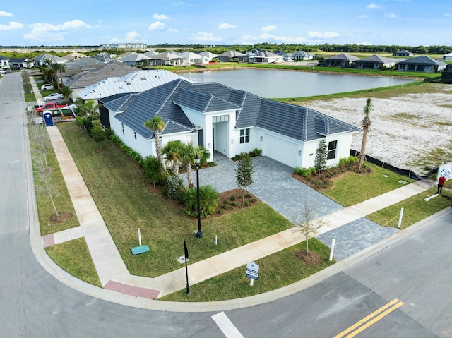 birds eye view of property with a water view and a residential view