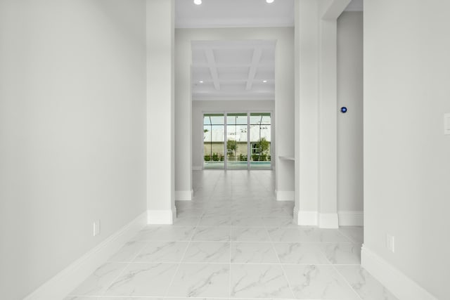 hall with marble finish floor and baseboards