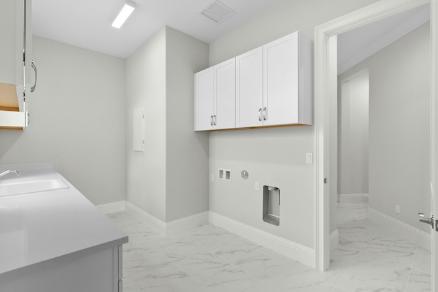 clothes washing area with marble finish floor, cabinet space, a sink, and baseboards