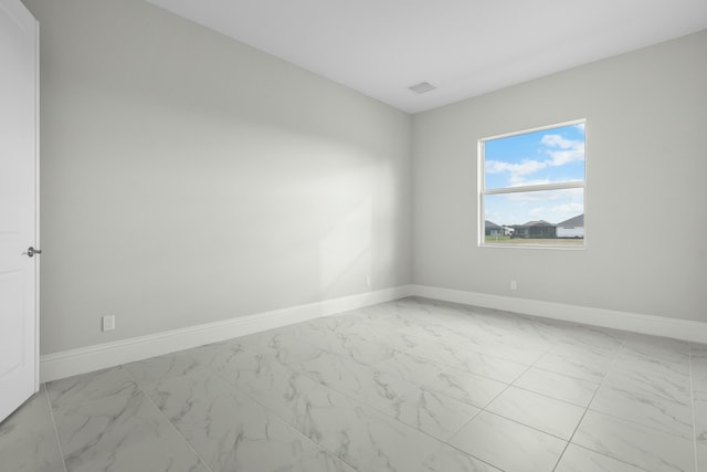 unfurnished room featuring marble finish floor, visible vents, and baseboards