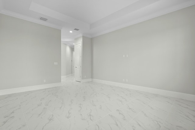 empty room with marble finish floor, baseboards, visible vents, and a tray ceiling